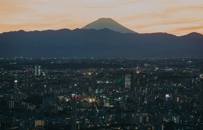 High angle view of city lit up at night