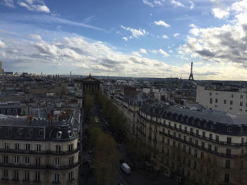 Buildings against cloudy sky