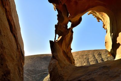 Rock formations on landscape against clear sky