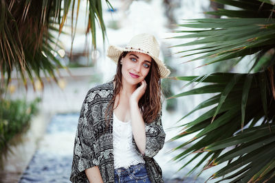 Portrait of young woman wearing hat