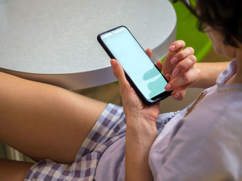 Midsection of woman using mobile phone