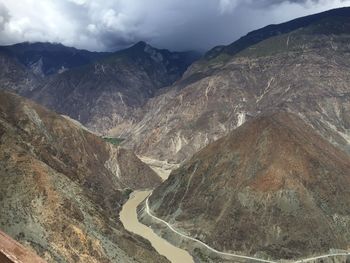 Scenic view of mountains against cloudy sky