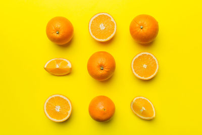 Close-up of oranges against yellow background