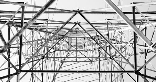 Directly below shot of electricity pylon against sky