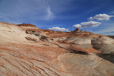 Sand dunes in desert against sky