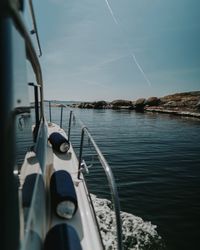 Sailboats sailing in sea against sky