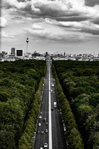 Road amidst buildings in city against sky