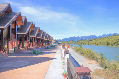 View of swimming pool by lake against sky