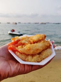 Close-up of hand holding seafood