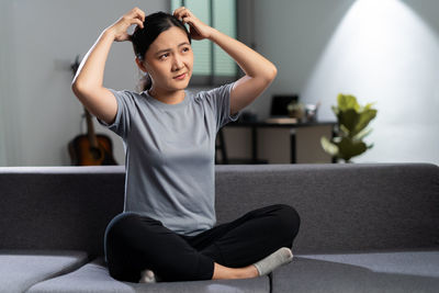 Portrait of young woman exercising at home