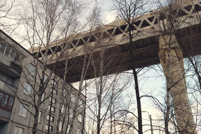 Low angle view of arch bridge and building against sky