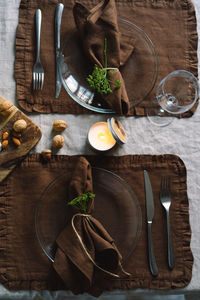 Vintage table setting with linen napkins and floral decorations. close up.