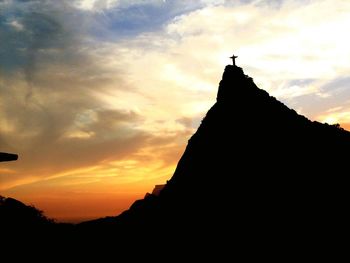 Low angle view of silhouette mountain against dramatic sky