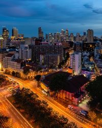 High angle view of illuminated street amidst buildings in city