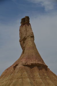 Low angle view of rock formation against sky