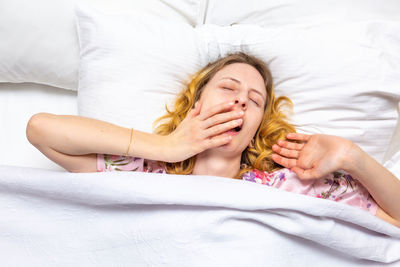 Young woman sleeping in bed