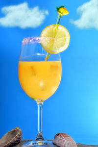 Orange juice cocktail on the beach sand