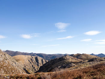 Scenic view of mountains against blue sky