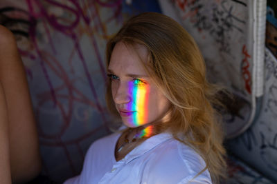 Side view of thoughtful woman sitting at home