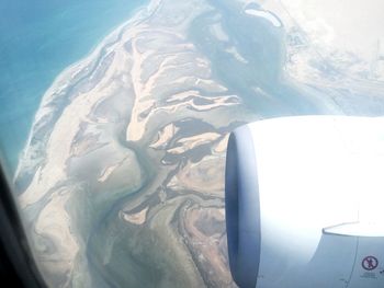 Aerial view of landscape seen through airplane window