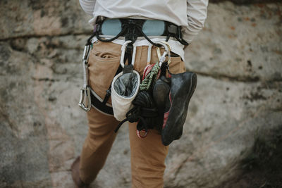 Rear view of man with climbing equipment
