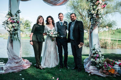 Friends standing by flower bouquet