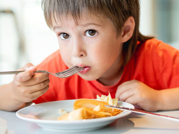 Close-up of boy eating food