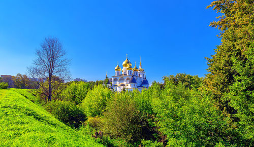 Blue sky sunny landscape with russian orthodox cathedral with shiny golden cupola
