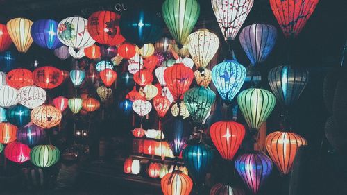 Colorful lanterns hanging for sale at night