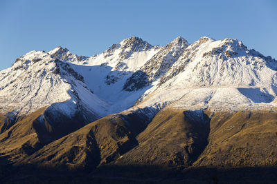 Scenic view of snowcapped mountains against clear sky