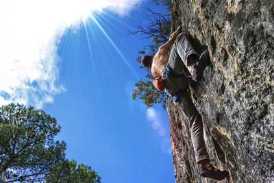 Low angle view of woman against blue sky