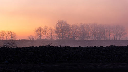 Scenic view of landscape against sky during sunrise