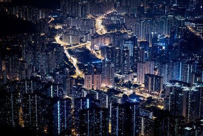Illuminated cityscape against sky at night