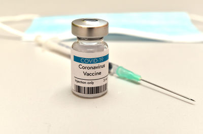 Coronavirus covid-19 vaccine vial, container, bottle and syringe
