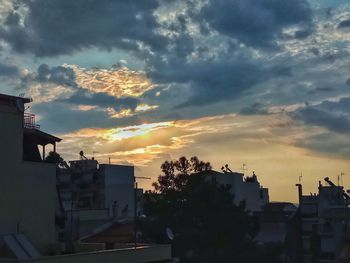 Silhouette buildings against sky during sunset