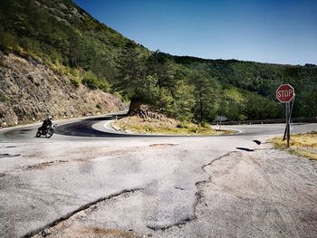 Road by mountain against clear sky