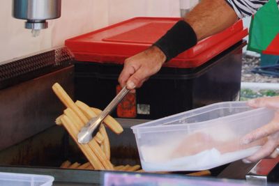 Cropped hands of man preparing food at market