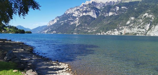 Scenic view of sea and mountains against sky