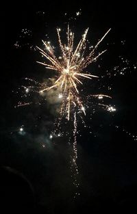 Low angle view of firework display at night