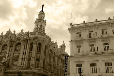 Low angle view of building against cloudy sky