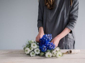 Woman making a flower arrangement