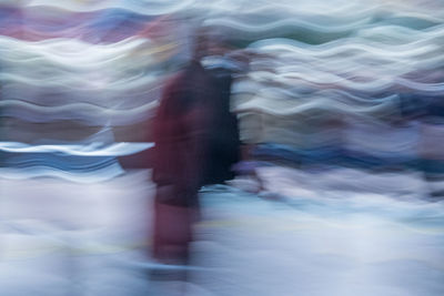 Blurred motion of woman walking in water