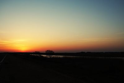 Scenic view of silhouette landscape against clear sky during sunset