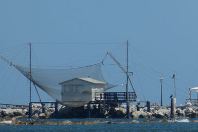 Low angle view of ship against clear blue sky