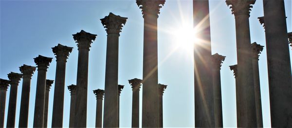 Low angle view of colonnade against clear sky