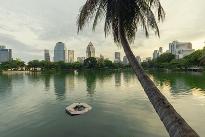 Scenic view of lake by buildings against sky