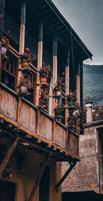 Low angle view of old buildings by sea against sky