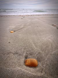 Close-up of sand on beach against sky