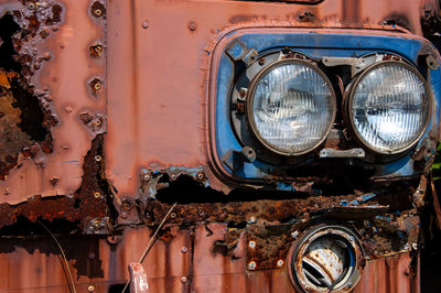 Close-up of headlight of rusty vehicle