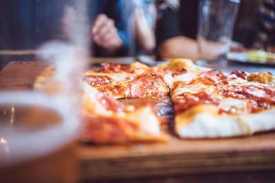 Beer and rustic pizza served on table